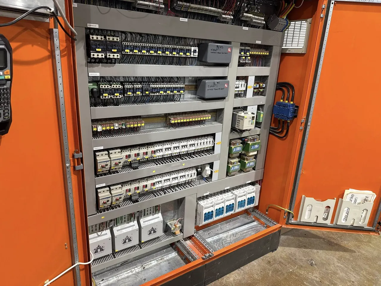 Open refrigeration control panel during a maintenance visit
